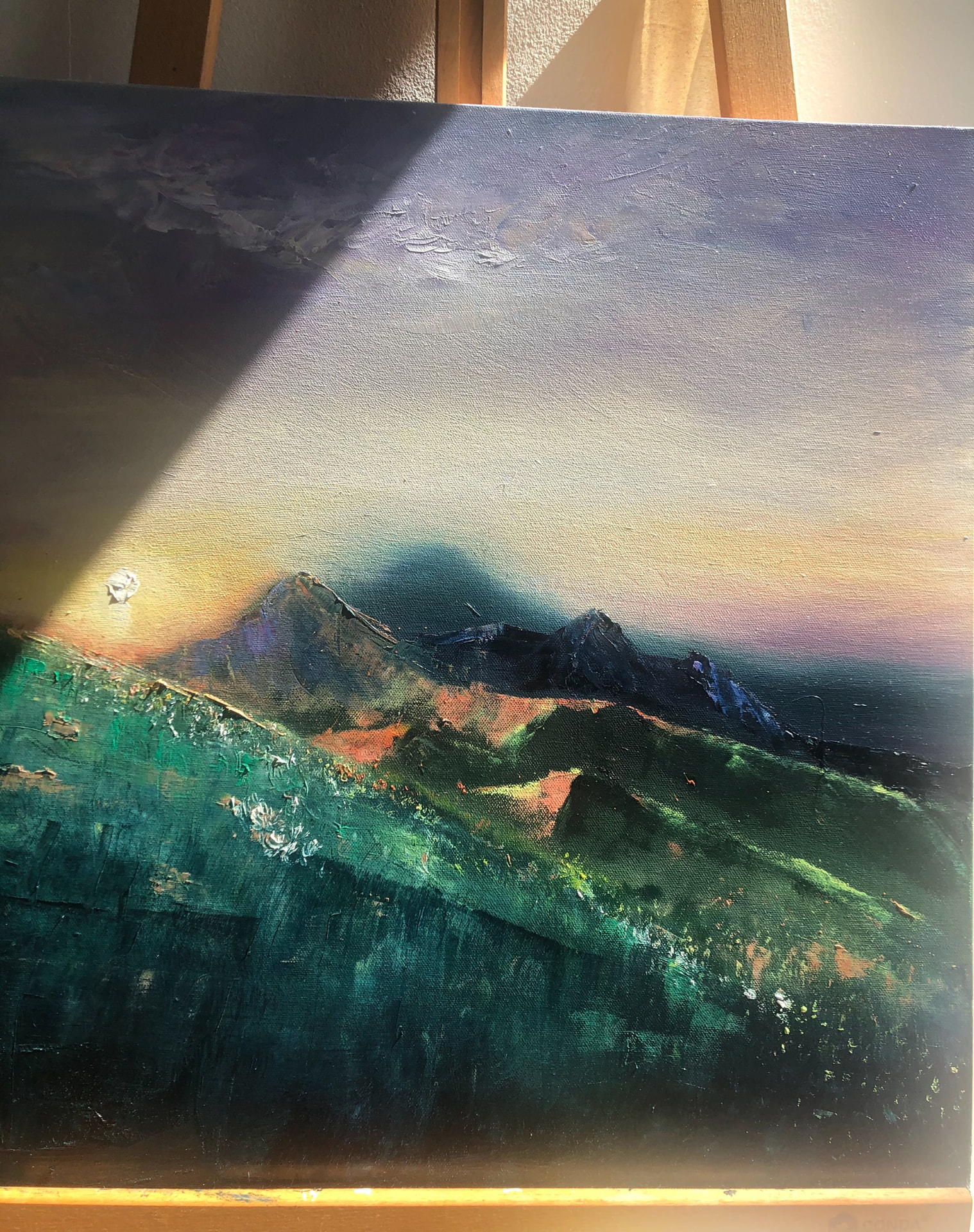 Textured mountain landscape painting illuminated by warm light